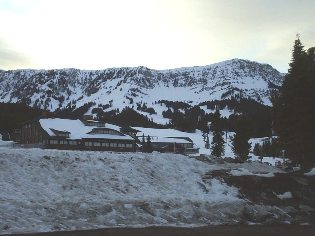 Snow-covered Bridger Bowl base lodge below the Bridger Range ridgeline near Bozeman, Montana