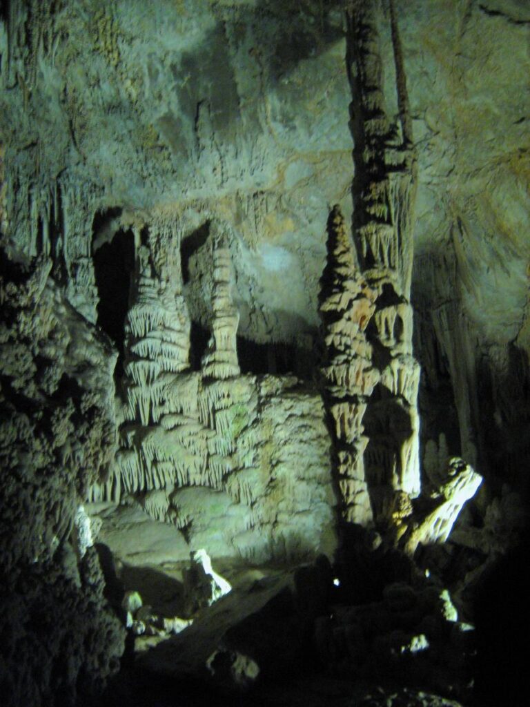 Lit limestone columns and stalactites inside Lewis and Clark Caverns State Park, Montana
