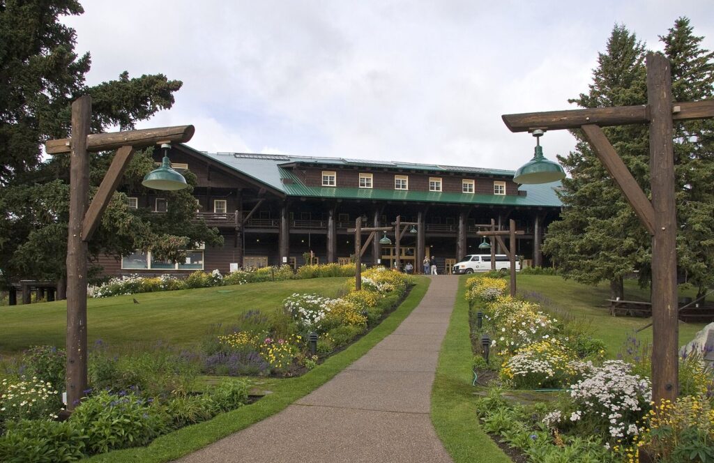 Glacier Park Lodge in East Glacier Park, Montana, with timber entry posts and summer flower gardens