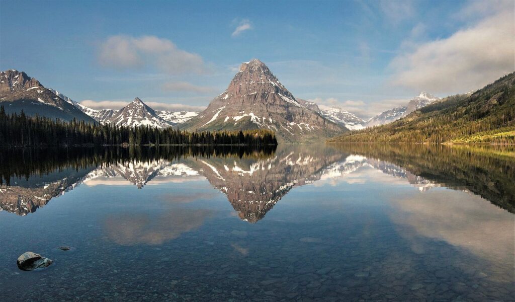 Sinopah Mountain reflected in calm Two Medicine Lake on the east side of Glacier National Park